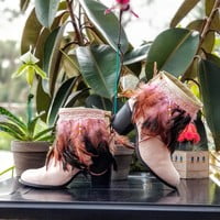 Light pink feathers, one peacock feather, off white base