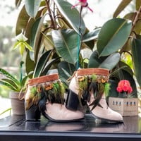 Green feathers, brown feathers, brown leather