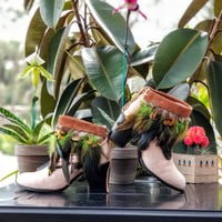 Green feathers, brown feathers, brown leather