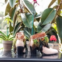 Green feathers, brown feathers, brown leather