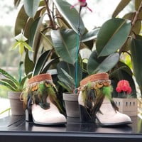 Green feathers, brown feathers, brown leather